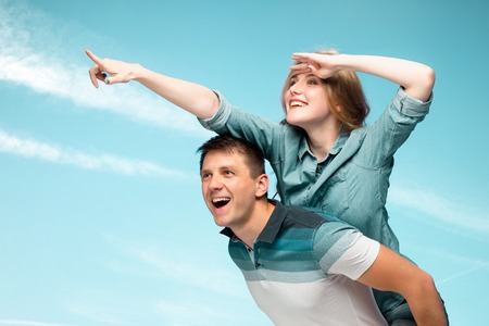 Young couple smiling under blue sky