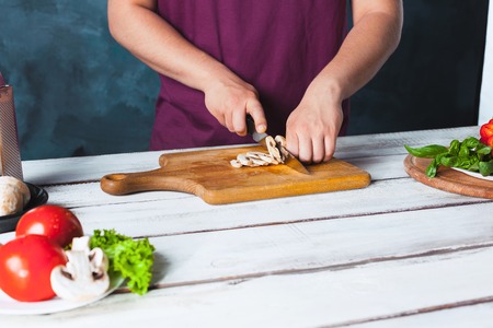 Closeup hand of chef baker making pizza at kitchenの写真素材