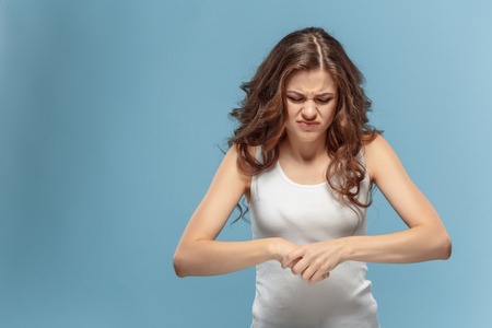 unhappy woman suffering from pain in handの写真素材