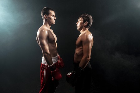 Two professional boxer standing on black smoky background,の写真素材