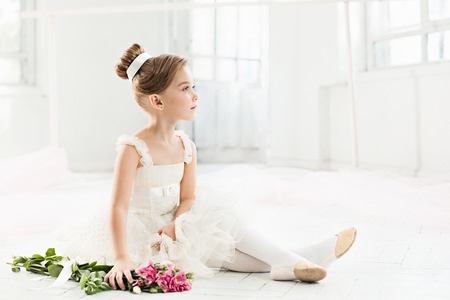 The little balerina in white tutu in class at the ballet schoolの写真素材