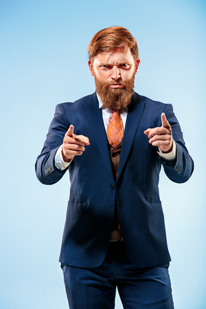 Portrait of a business man isolated on blue background.の写真素材