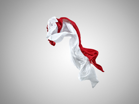 Smooth elegant transparent red and white cloth separated on gray background.の写真素材