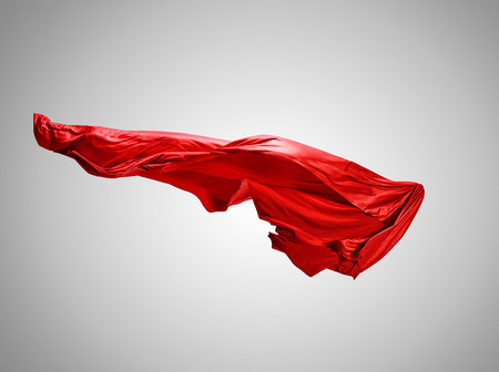Smooth elegant transparent red cloth separated on gray background.の写真素材