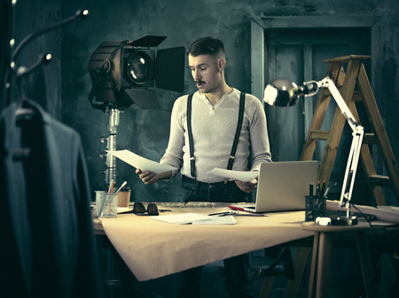 Architect working on drawing table in officeの写真素材