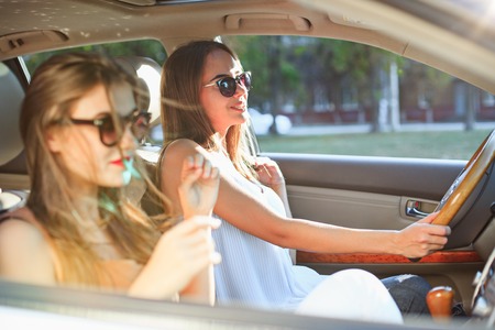 young women in the car smilingの写真素材