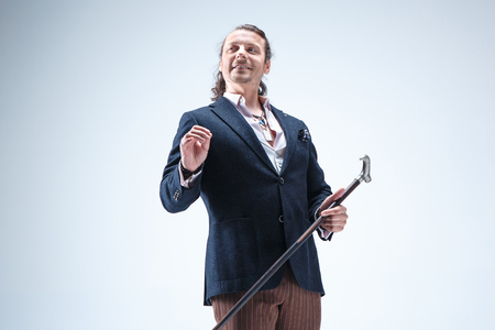 The mature barded man in a suit holding cane.の写真素材