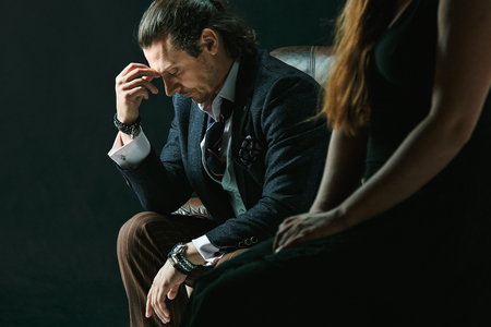 The artist or mature man wearing suit in a classical retro fashion style. The woman standing nearの写真素材