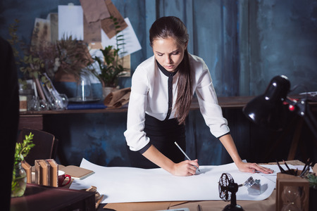Architect working on drawing table in office