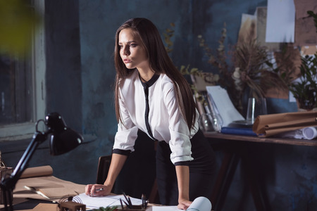 Architect working on drawing table in officeの写真素材