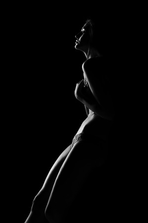 Black and white silhouette of young, sporty and sexy woman in lingerieの写真素材