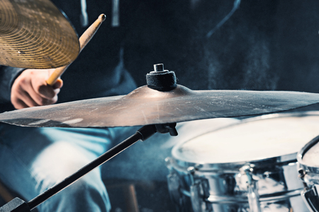 Drummer rehearsing on drums before rock concert. Man recording music on drum set in studioの写真素材