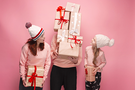 Father and mother give gifts to little daughter at studioの写真素材