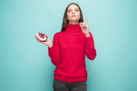 Beautiful woman holding small cake.