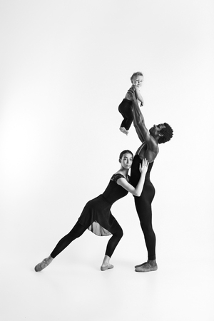 A happy family of ballet dancers on white studio backgroundの写真素材
