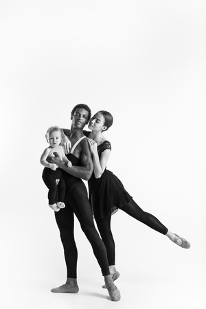 A happy family of ballet dancers on white studio backgroundの写真素材