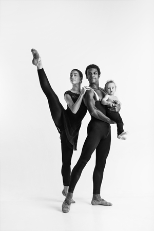 A happy family of ballet dancers on white studio backgroundの写真素材