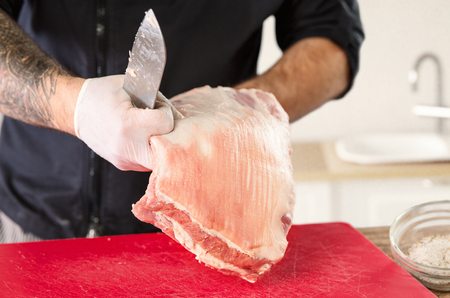 Man cooking meat steak on kitchenの写真素材