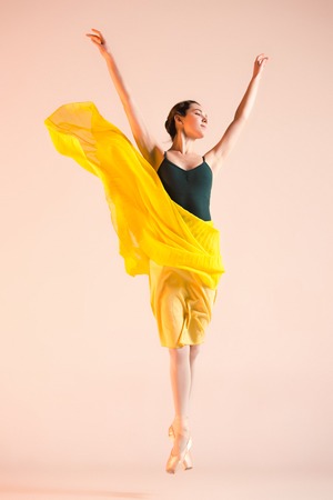 Young and incredibly beautiful ballerina is dancing at studioの写真素材
