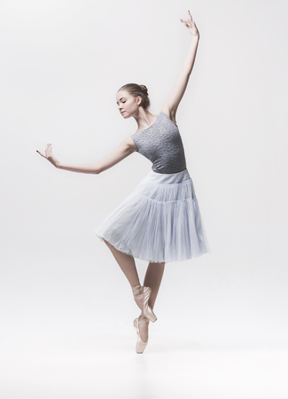 Young classical dancer isolated on white background.の写真素材