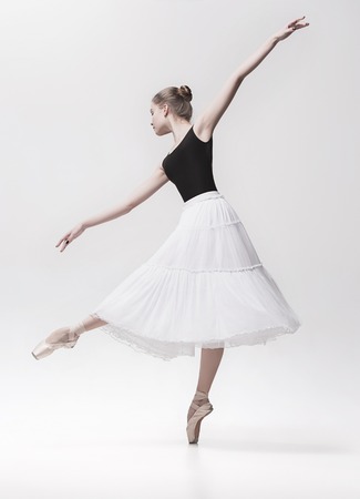 Young classical dancer isolated on white background.の写真素材