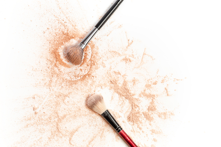Close-up of crushed mineral shimmer powder golden color with makeup brushの写真素材