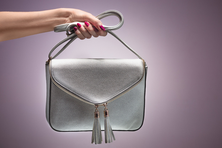 Fashion. Female hand Stylish Trendy Handbag clutchの写真素材