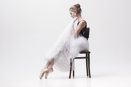 The teen ballerina in white pack sitting on chairの写真素材