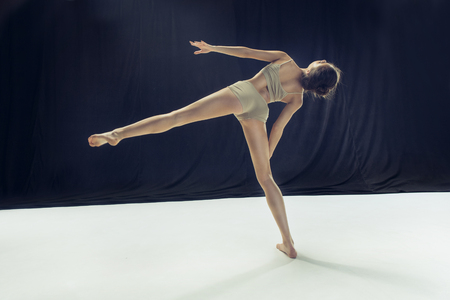 Young teen dancer ion white floor background.の写真素材