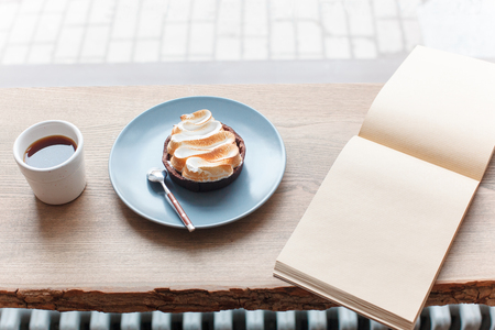 Cup of coffee, branch of tree, wooden windowsillの写真素材