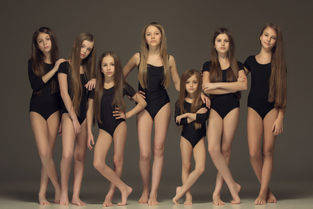 The group of teen girls posing at white studioの写真素材