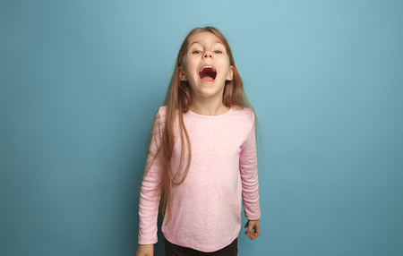 The emotional blonde teen girl have a happiness look and screaming. Studio shotの写真素材
