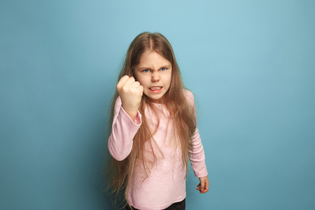 The cry. Teen girl on a blue background. Facial expressions and people emotions conceptの写真素材