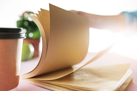 The business woman in the workplace flips through the dailybookの写真素材