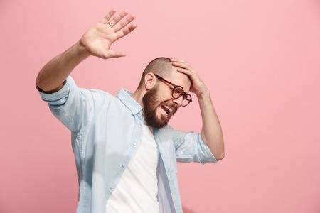 Portrait of the scared man on pink