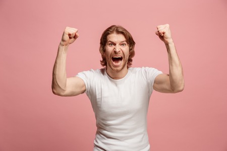 Winning success man happy ecstatic celebrating being a winner. Dynamic energetic image of male modelの写真素材