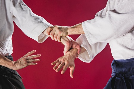 Two men fighting at Aikido training in martial arts schoolの写真素材