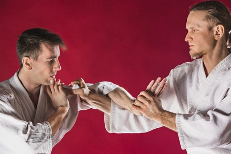 Two men fighting at Aikido training in martial arts schoolの写真素材