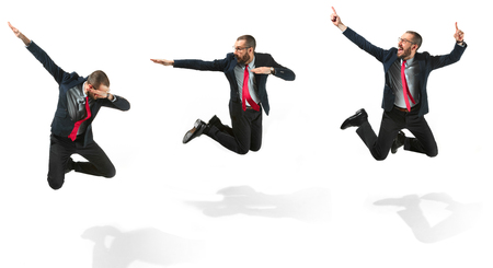 Funny cheerful businessman jumping in air over white backgroundの写真素材