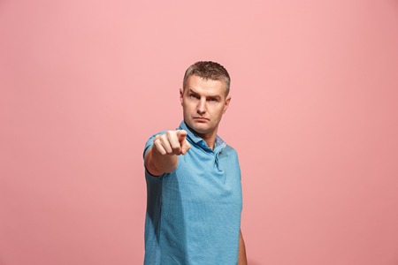 The serious business man point you and want you, half length closeup portrait on pink background.の写真素材