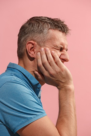 Young man is having toothache.