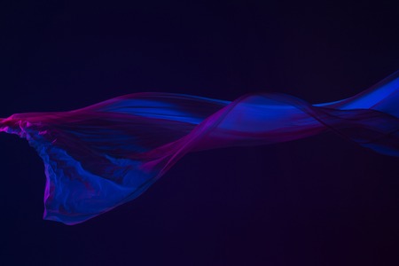 Smooth elegant transparent blue cloth separated on blue background.