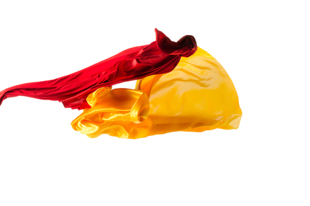 Smooth elegant transparent yellow, red, cloth separated on white background.の写真素材