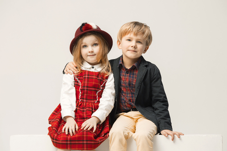 Cute stylish children on white studio backgroundの写真素材