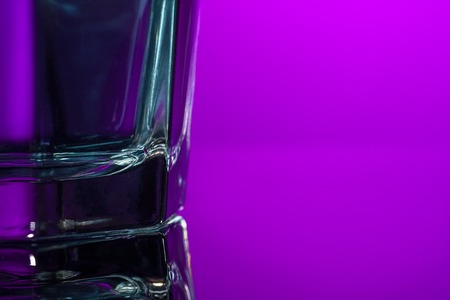 The water in glass on lilac backgroundの写真素材