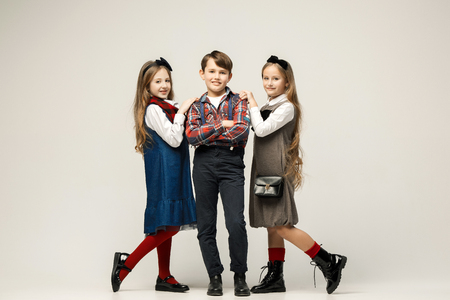 Cute stylish children on white studio backgroundの写真素材