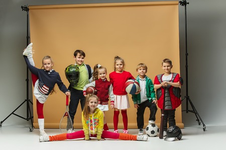 Group of happy children show different sport. Studio fashion concept. Emotions concept.の写真素材