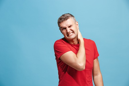 Young man overwhelmed with a pain in the neck .の写真素材