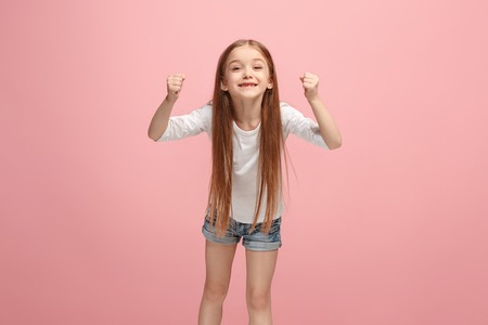 Happy success teen girl celebrating being a winner. Dynamic energetic image of female modelの写真素材