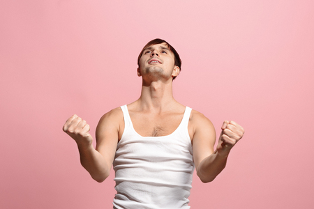Winning success man happy ecstatic celebrating being a winner. Dynamic energetic image of male modelの写真素材